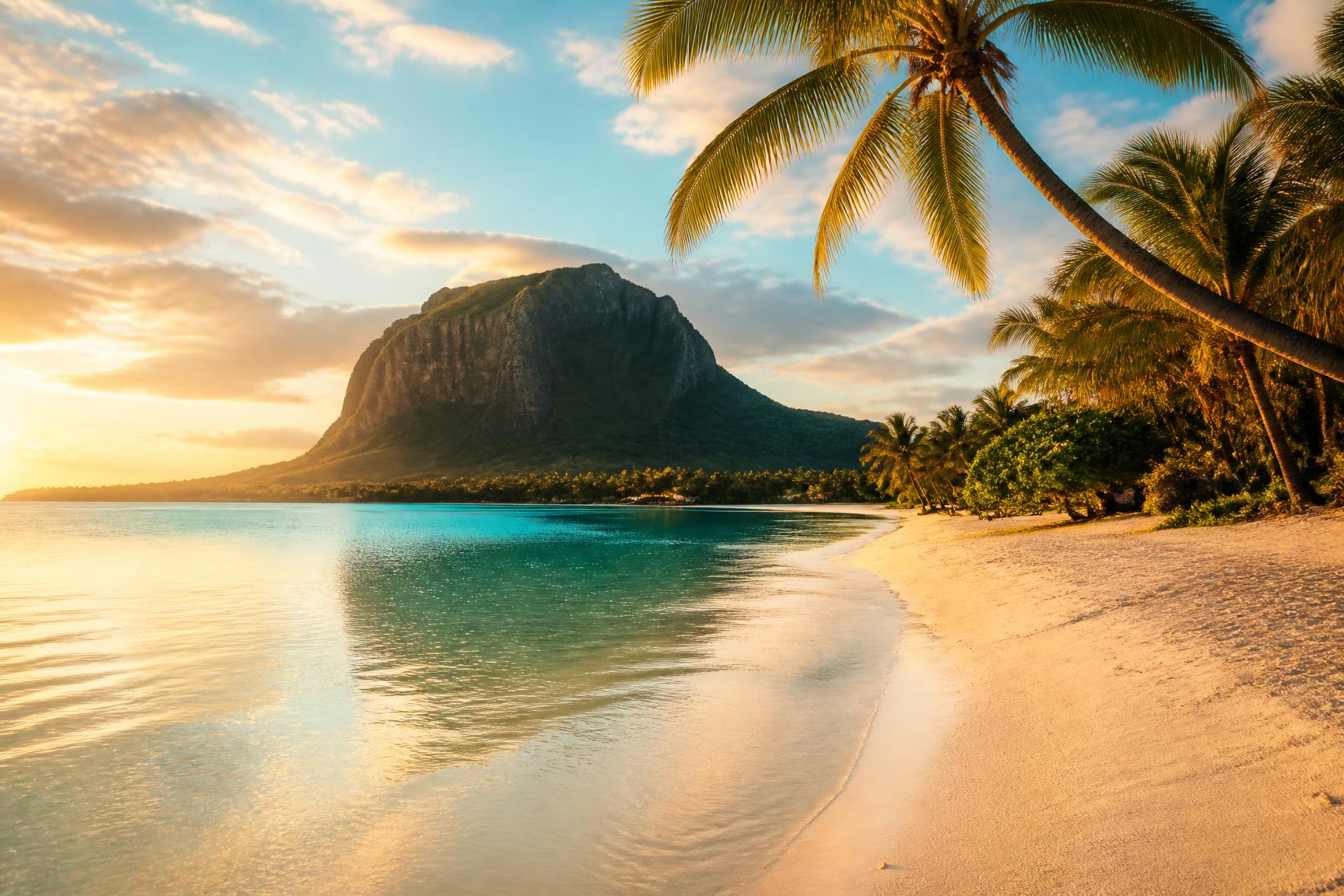 Mauritius lagoon with white sand beach, palm tree and Le Morne Brabant mountain
